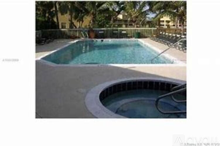 A pool with a hot tub in the middle of it.