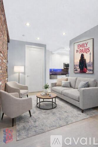 A living room with a couch, chairs, and a poster of "Emily in Paris".