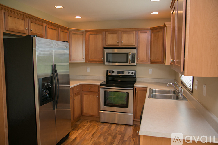 A kitchen with wooden cabinets and stainless steel appliances.
