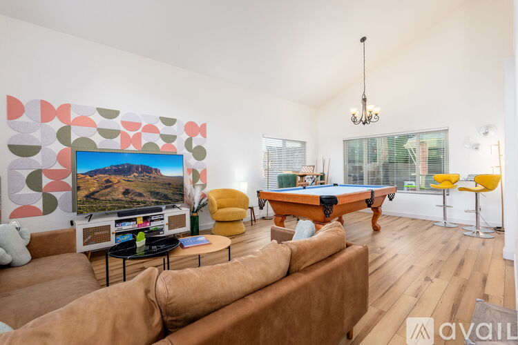 A living room with a pool table and a couch.