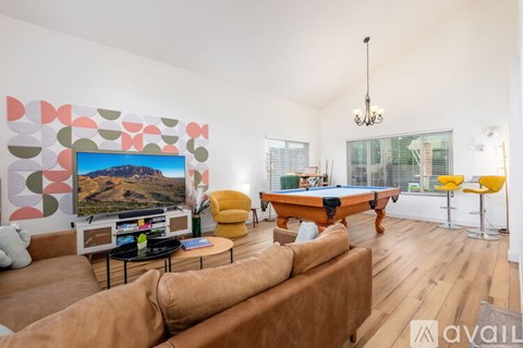 A living room with a pool table and a couch.