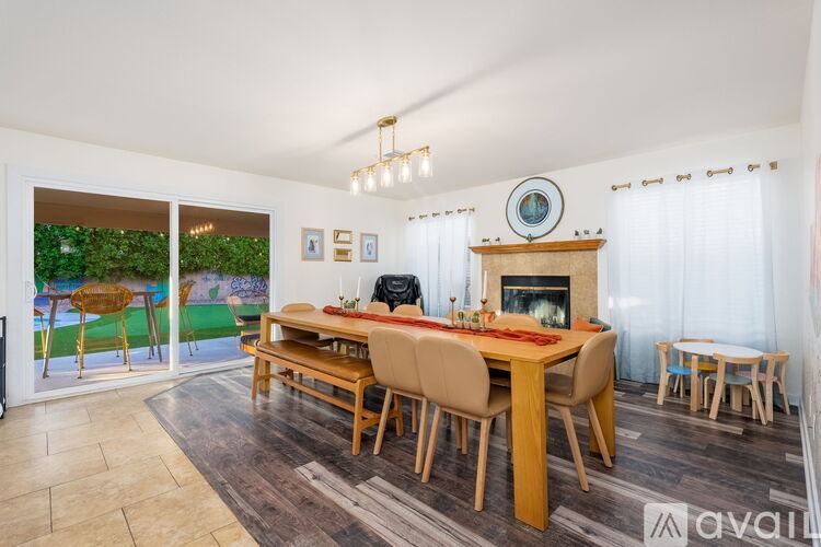 A dining room with a wooden table and chairs.