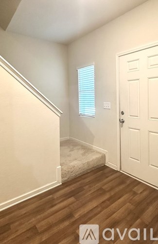 A room with wooden floors and a white door.