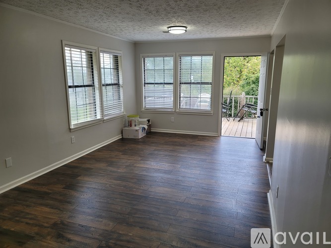 A room with wooden floors and white walls.