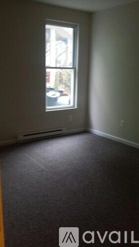 A room with a car parked outside the window.