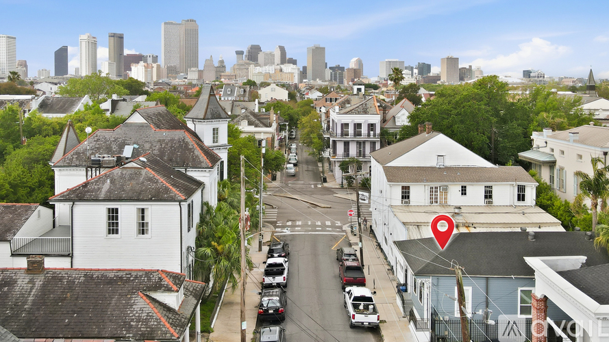 A street view of a town with buildings and cars.