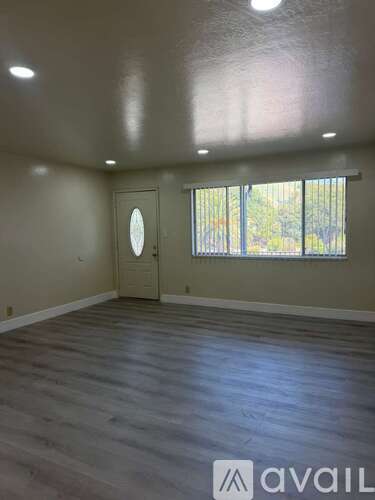 A room with a door and a window with Avail logo on the floor.