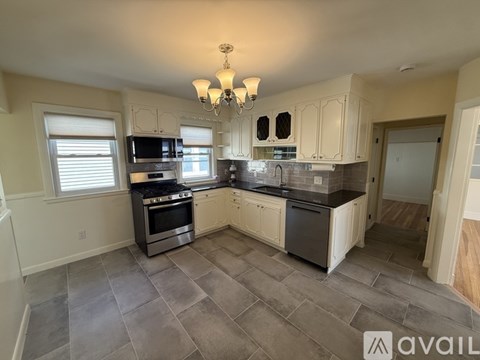 A kitchen with a black stove top oven and a black dishwasher.