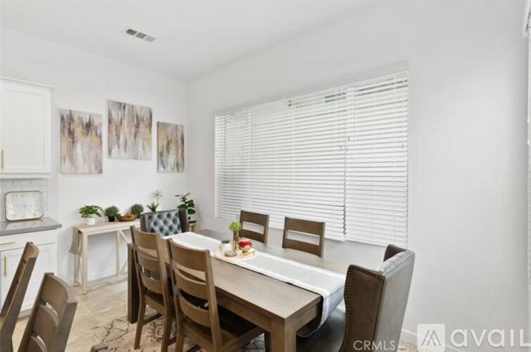 A dining room with a table set for six people.
