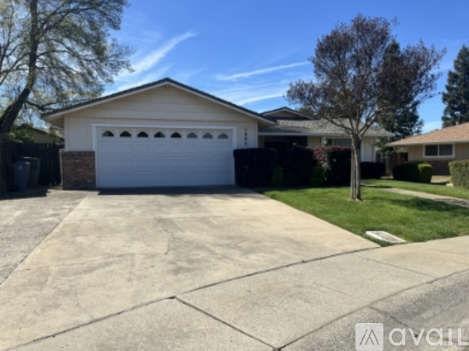 A house with a white garage door is for sale.