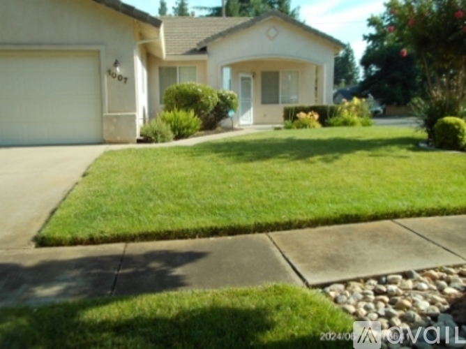 A house with a white garage door and a brown roof.