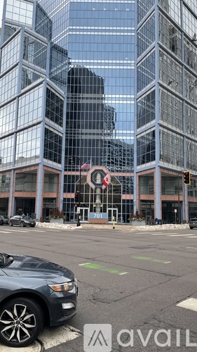 A car is parked in front of a building with a sign that reads "701.".