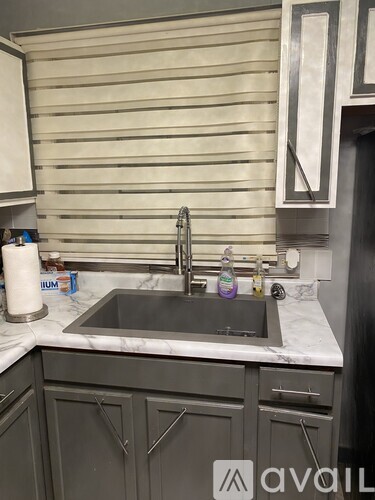 A kitchen with a sink and a counter.