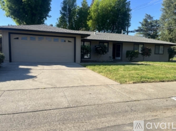 A house with a garage and a driveway in front.