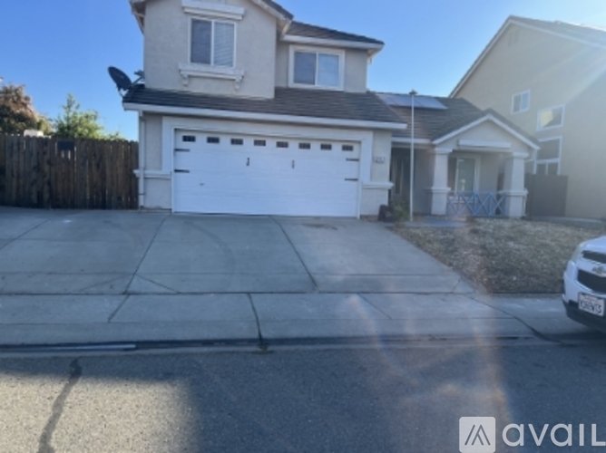 A house with a white garage door is for sale.