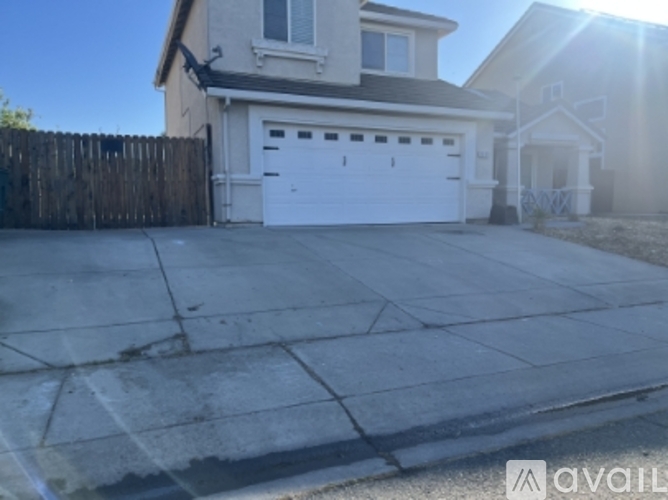 A house with a white garage door is for sale.