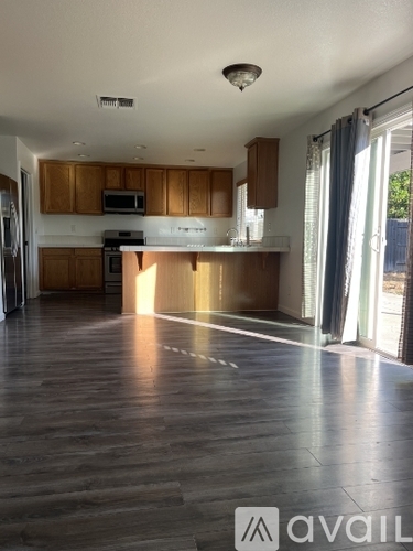 A kitchen with wooden cabinets and a refrigerator.