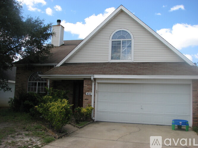A house with a garage door and a window is for sale.