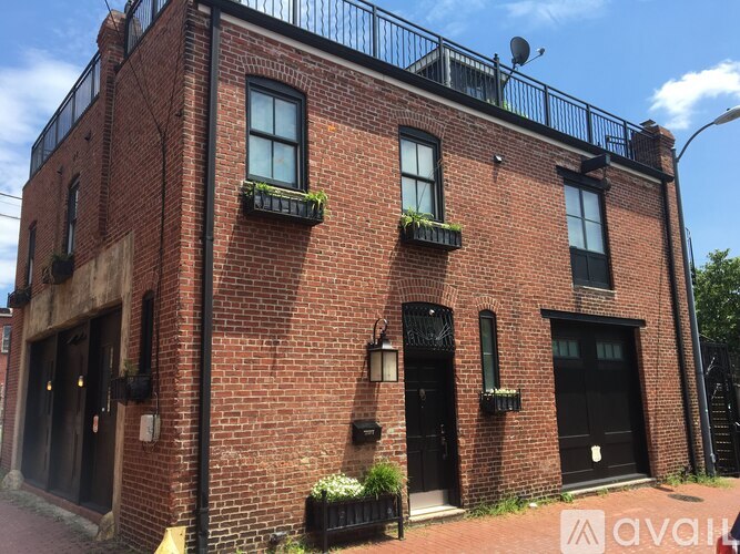 A red brick building with black doors and windows.