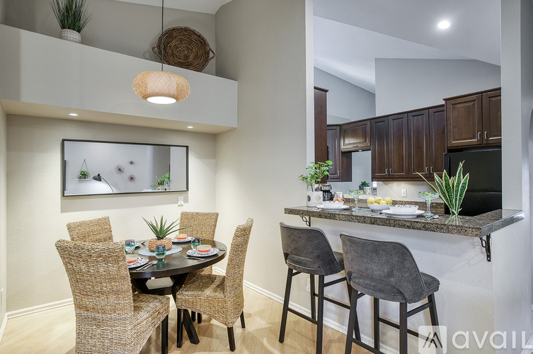 A modern dining room with a table set for four.