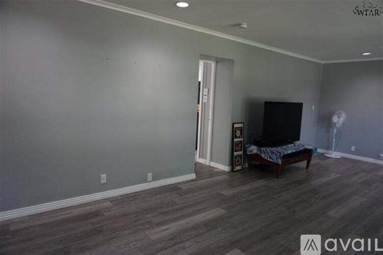A living room with a television and a couch.
