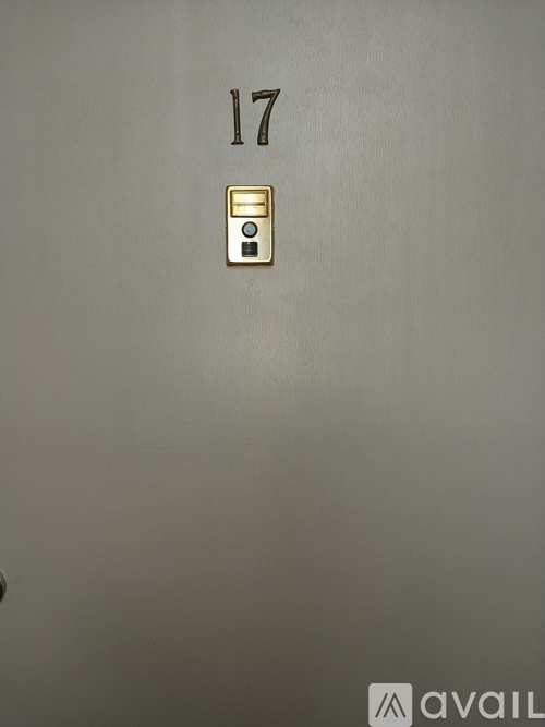 A wall with the number 17 and a light switch.
