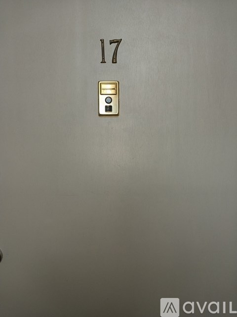 A wall with the number 17 and a light switch.