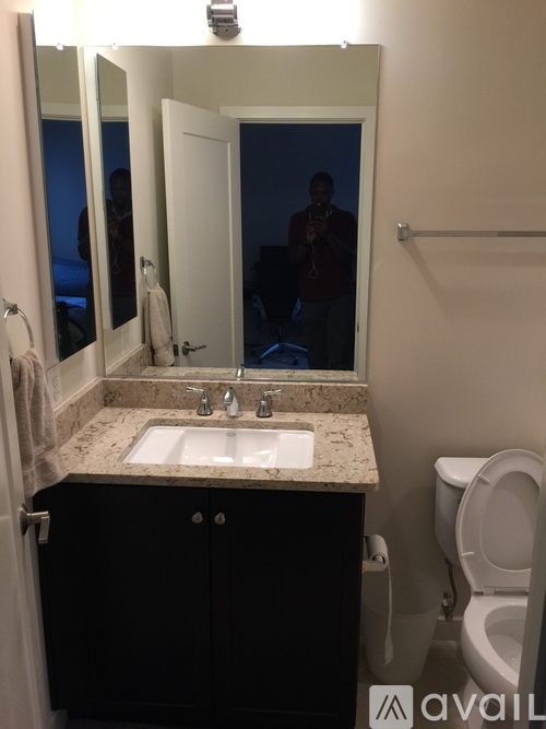 A bathroom with a sink, mirror, and toilet.