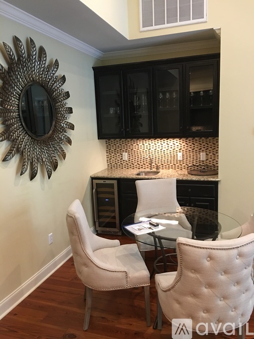 A modern dining room with a glass table and chairs.
