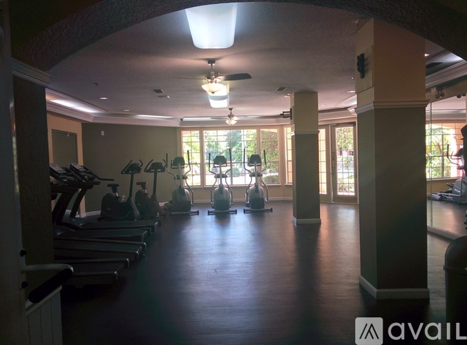 A gym with treadmills, elliptical machines, and other exercise equipment.