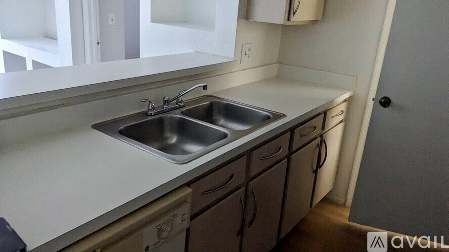 A kitchen with a sink and cabinets.