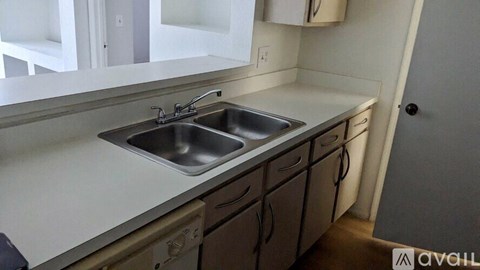 A kitchen with a sink and cabinets.
