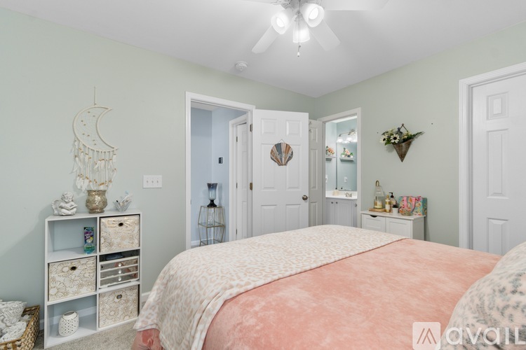 A bedroom with a bed, a dresser, and a mirror.