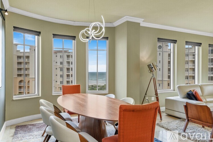 A dining room with a wooden table and chairs.