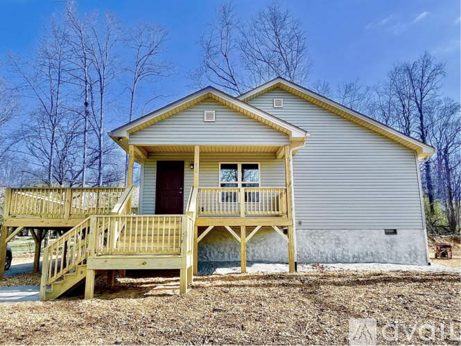 A house with a grey exterior and a yellow porch.