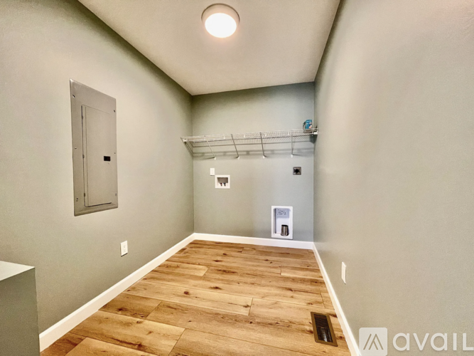 A room with wooden flooring and a white ceiling.
