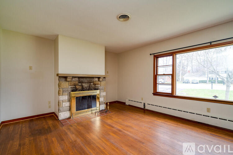 A living room with a fireplace and wood floors.