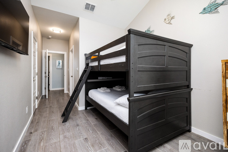 A bedroom with a bunk bed and a television.