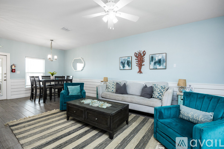 A living room with a sofa, coffee table, and dining table.