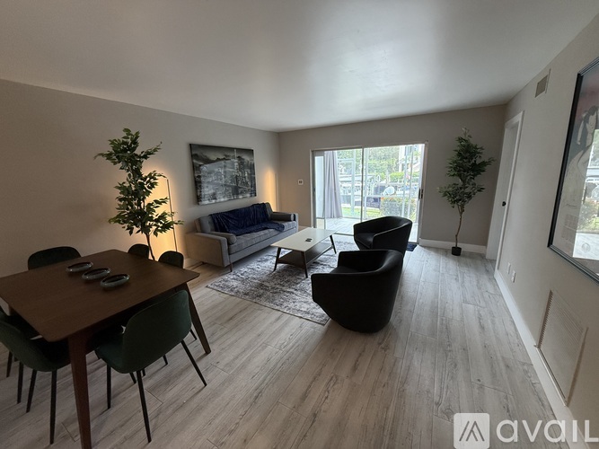 A living room with a dining table and chairs.