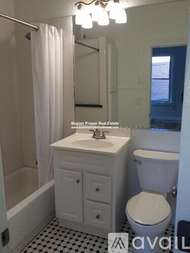 A white bathroom with a toilet, sink, and bathtub.