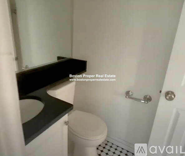 A bathroom with a toilet, sink, and shower.