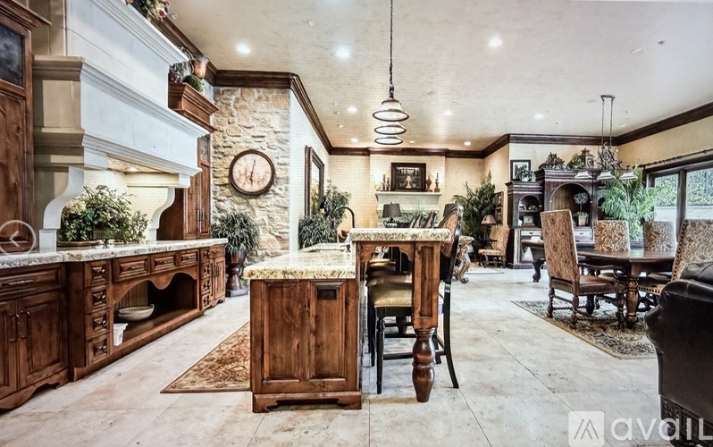 A kitchen with wooden cabinets and a marble countertop.