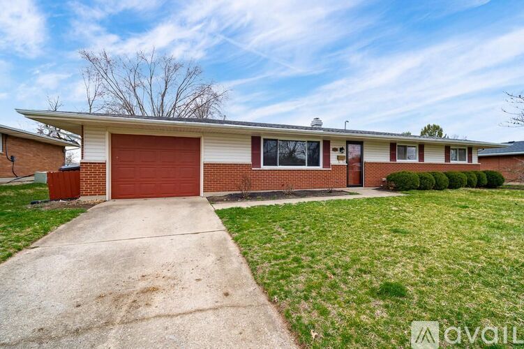 A house with a red garage door is for sale.