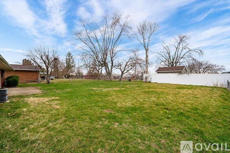 A backyard with a lawn and trees.