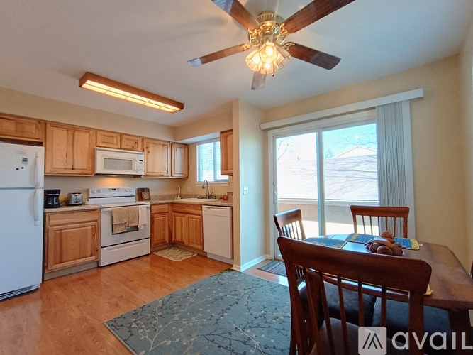 A kitchen with wooden cabinets and a white refrigerator.
