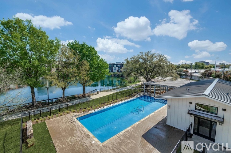 A swimming pool surrounded by a fence and trees.