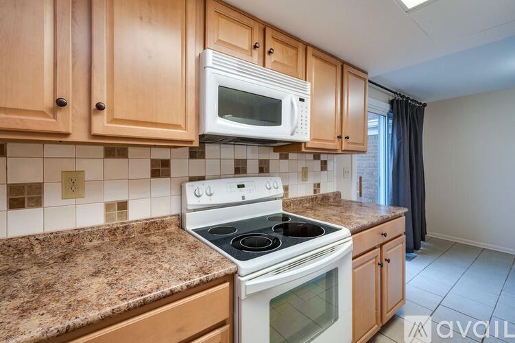 A kitchen with a stove top oven and microwave above it.