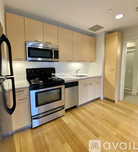 A kitchen with wooden cabinets and stainless steel appliances.