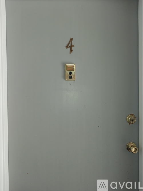 A white door with a number 4 and a lock.